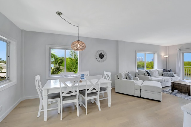 dining room with light wood-style flooring and baseboards