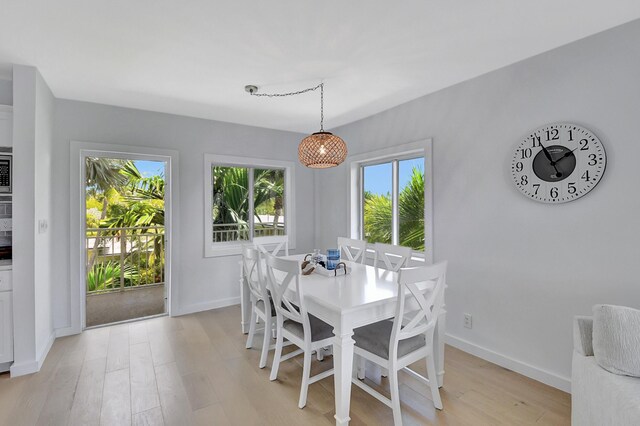 dining room with light wood-style flooring and baseboards