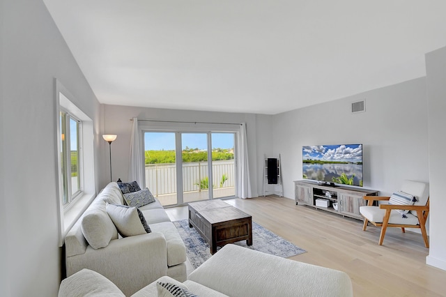 living room featuring light wood finished floors and visible vents