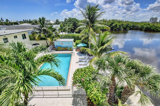 view of swimming pool featuring a patio area and a water view