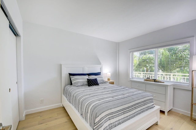 bedroom with a closet and light wood-type flooring