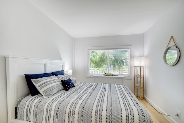 bedroom featuring light wood-type flooring and baseboards