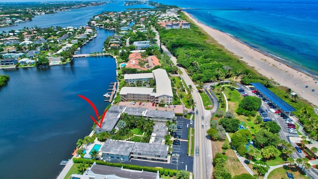 drone / aerial view with a water view and a view of the beach