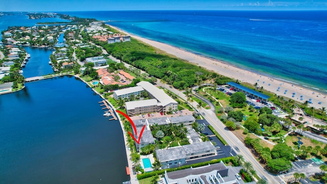 bird's eye view featuring a water view and a beach view