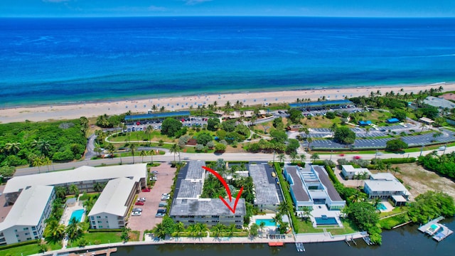 bird's eye view featuring a water view and a beach view