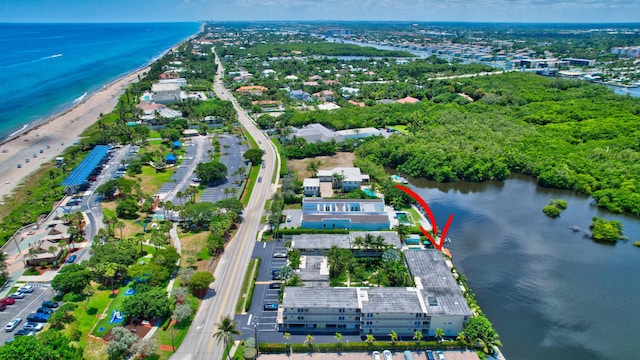 aerial view with a water view and a view of the beach