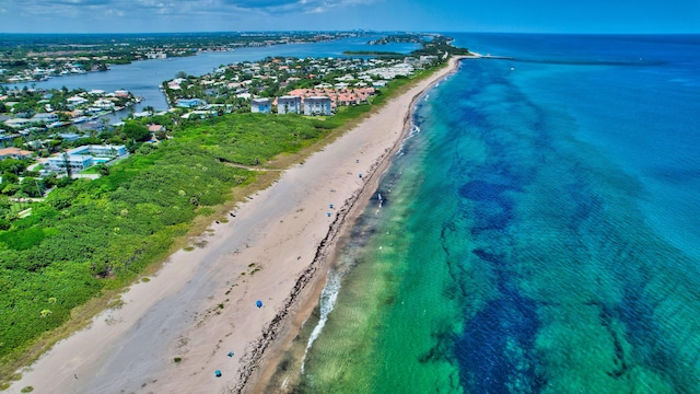 drone / aerial view featuring a water view and a beach view