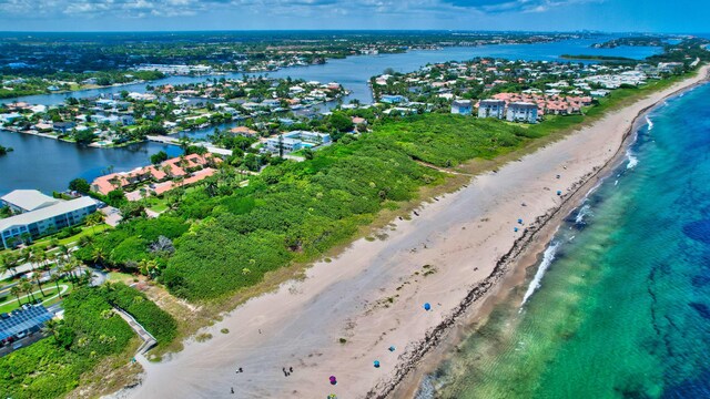 aerial view with a water view and a view of the beach