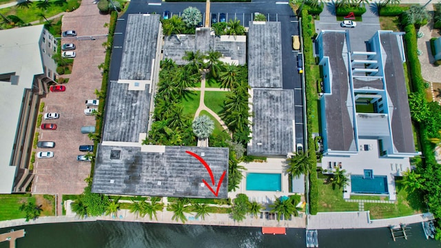 birds eye view of property with a water view