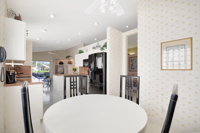 dining room with light tile patterned flooring, ceiling fan, and lofted ceiling