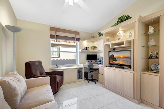 office area with light tile patterned flooring, built in desk, built in features, lofted ceiling, and ceiling fan