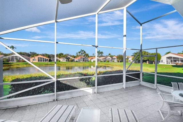 unfurnished sunroom with a water view