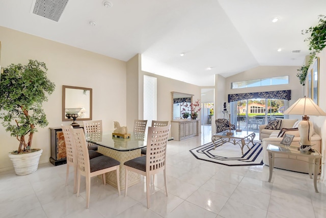 dining area featuring vaulted ceiling