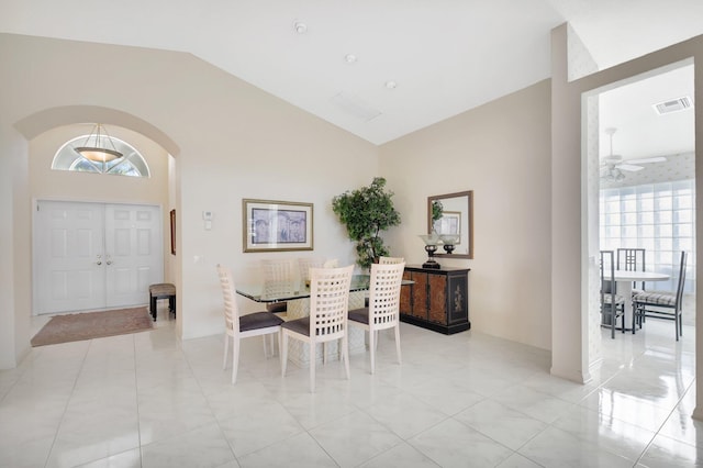 dining area with high vaulted ceiling and ceiling fan