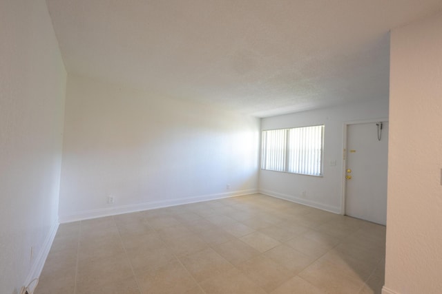 unfurnished room with a textured ceiling