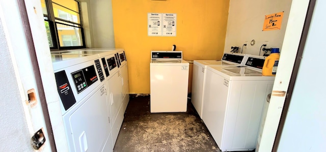 clothes washing area with washing machine and dryer