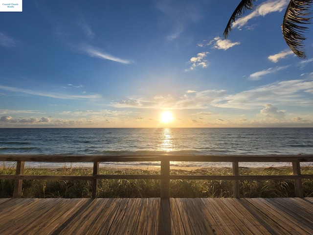 exterior space with a water view and a beach view