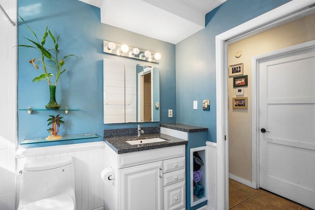 bathroom featuring tile patterned floors, vanity, and toilet