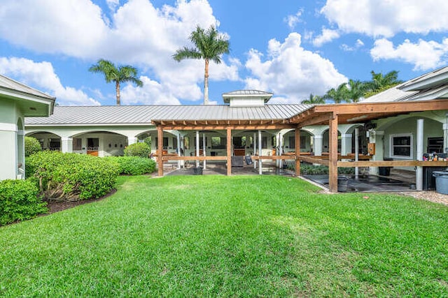 exterior space featuring metal roof, a yard, and a standing seam roof