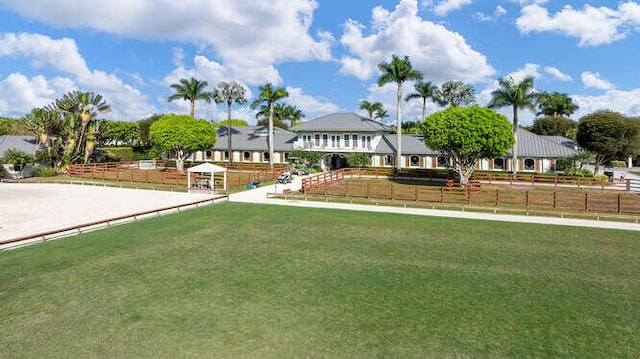 view of front of house featuring an enclosed area, a front yard, and fence