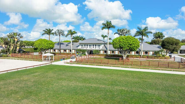 view of front of home with a front lawn and fence