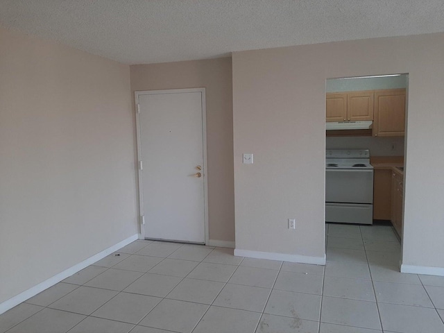 unfurnished room featuring light tile patterned flooring and a textured ceiling