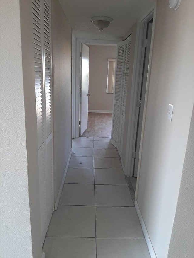 corridor featuring light tile patterned floors