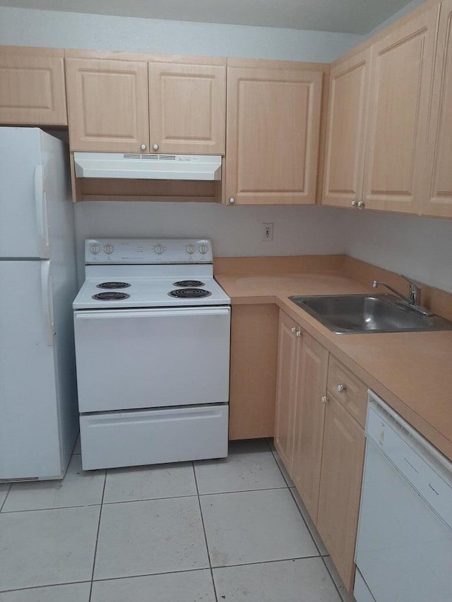 kitchen featuring light brown cabinetry, sink, white appliances, and light tile patterned flooring