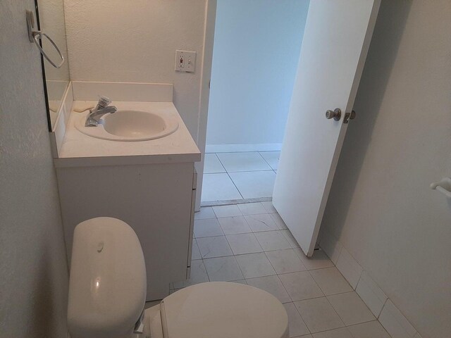 bathroom with vanity, tile patterned floors, and toilet