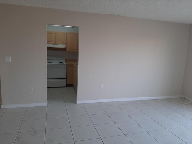 tiled empty room with a textured ceiling