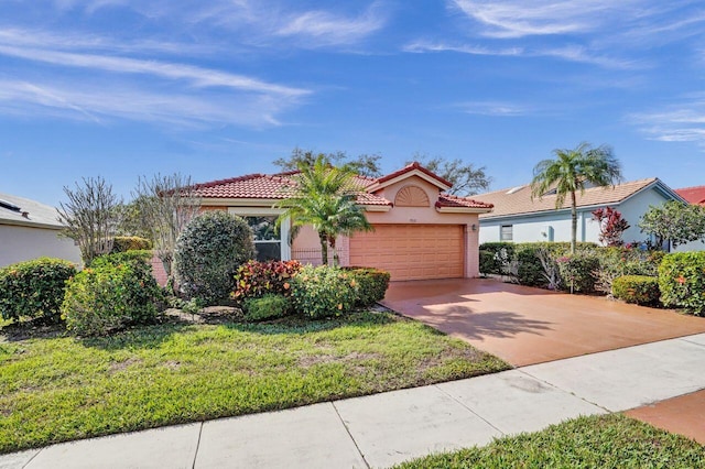 mediterranean / spanish home with a garage and a front yard