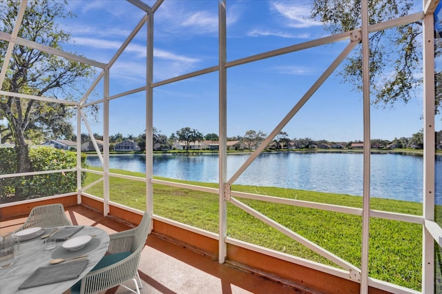 unfurnished sunroom featuring a water view