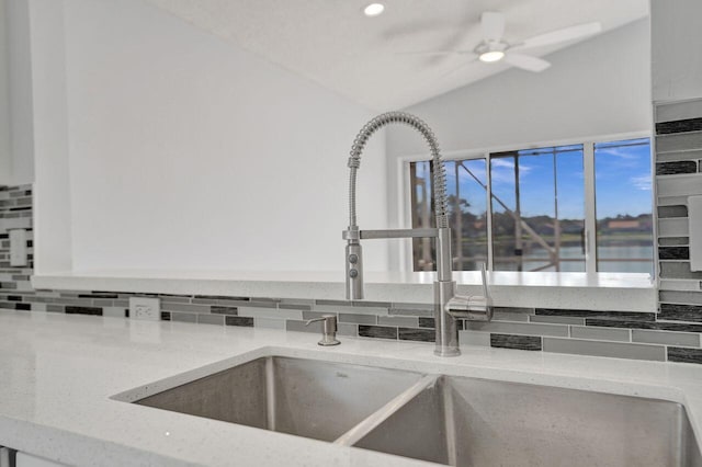 room details with a ceiling fan, light stone countertops, recessed lighting, a sink, and tasteful backsplash