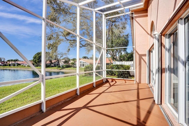 unfurnished sunroom featuring a water view