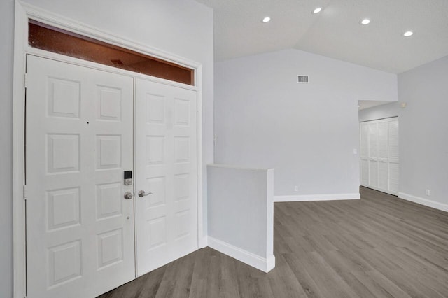 entrance foyer with lofted ceiling and hardwood / wood-style flooring