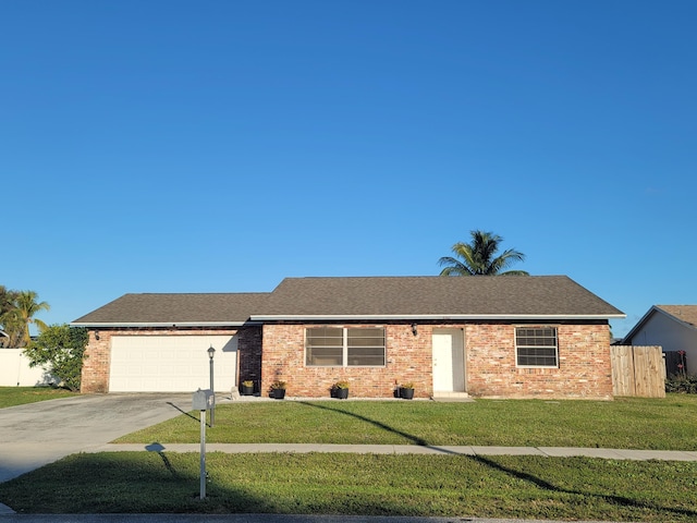 ranch-style home featuring a garage and a front lawn