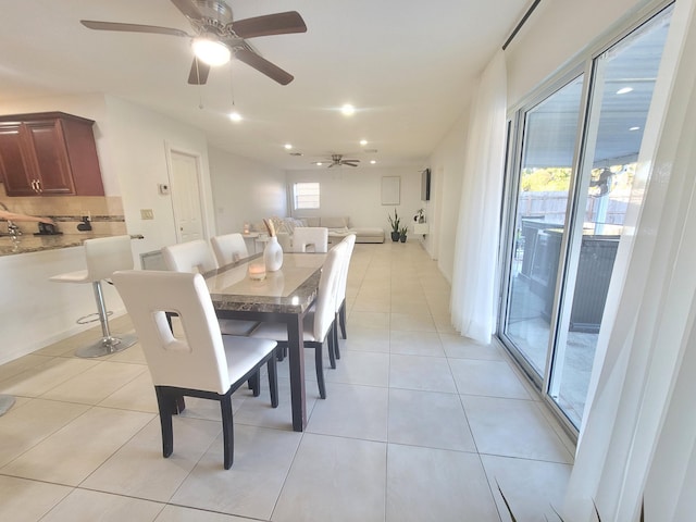 tiled dining space with ceiling fan