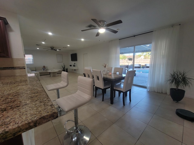 tiled dining room with ceiling fan