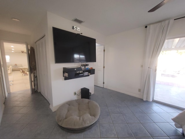 tiled living room featuring ceiling fan