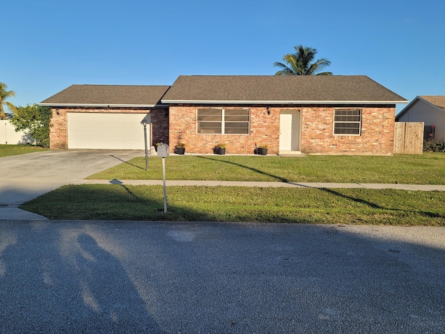 ranch-style house featuring a garage and a front yard