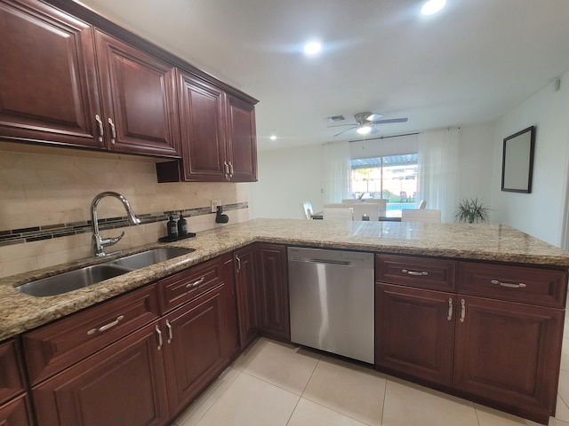 kitchen featuring light stone countertops, sink, stainless steel dishwasher, and kitchen peninsula