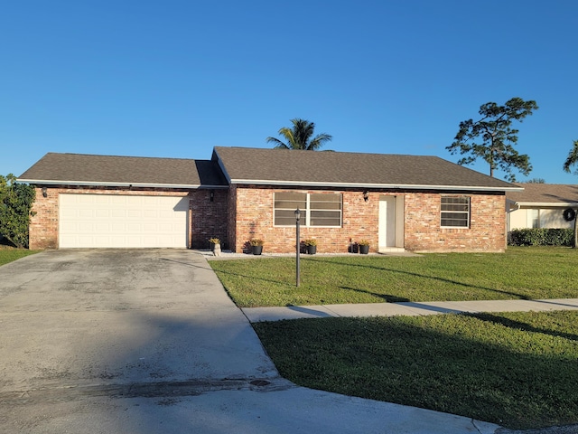 ranch-style house featuring a garage and a front yard