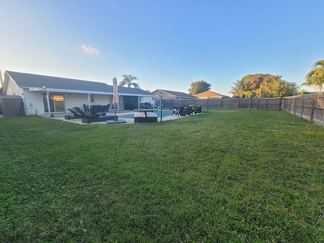 view of yard with a fenced in pool and a patio area