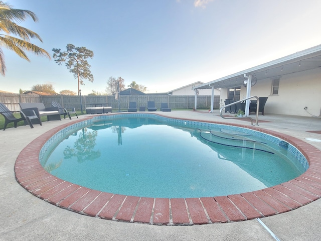 view of swimming pool featuring a patio area