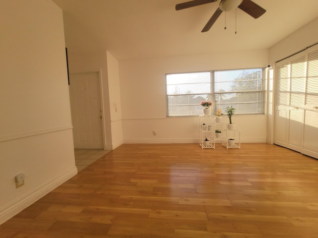 spare room with ceiling fan and light wood-type flooring