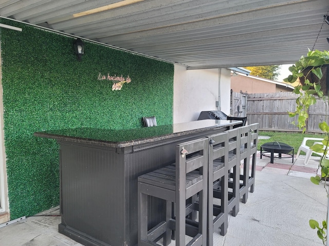 view of patio featuring a fire pit and a bar