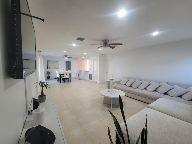 tiled living room with ceiling fan