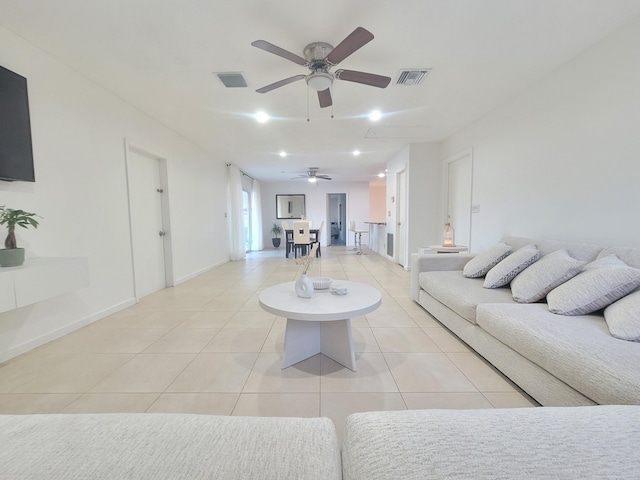 living room featuring ceiling fan and light tile patterned floors