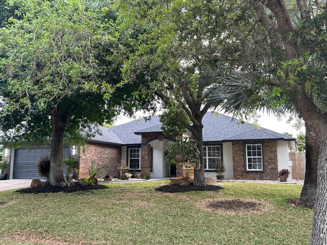 ranch-style home with roof with shingles, a garage, driveway, and stone siding
