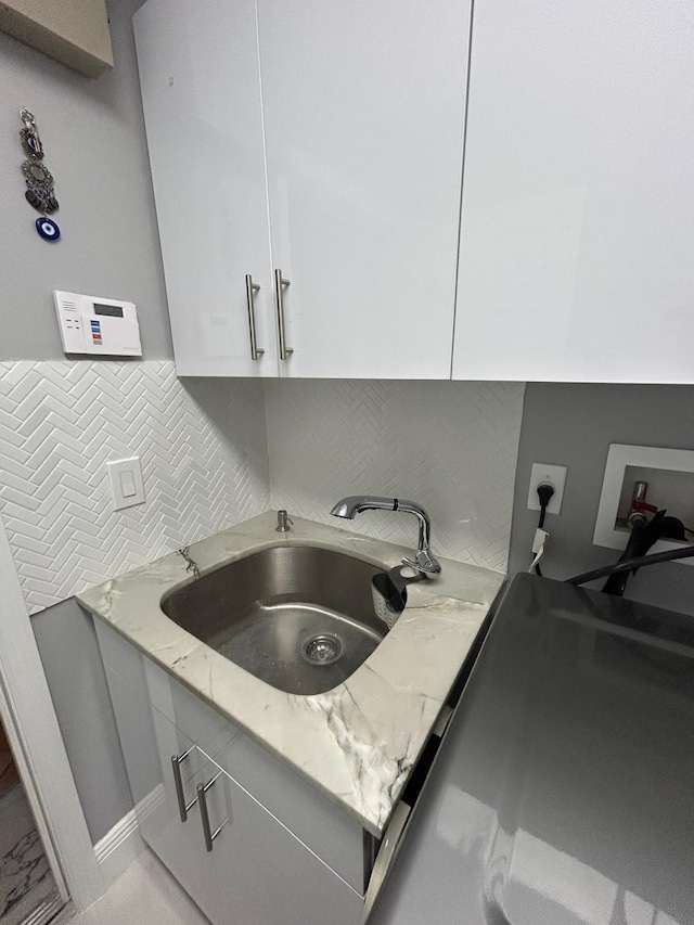 washroom featuring cabinet space, washer hookup, and electric dryer hookup